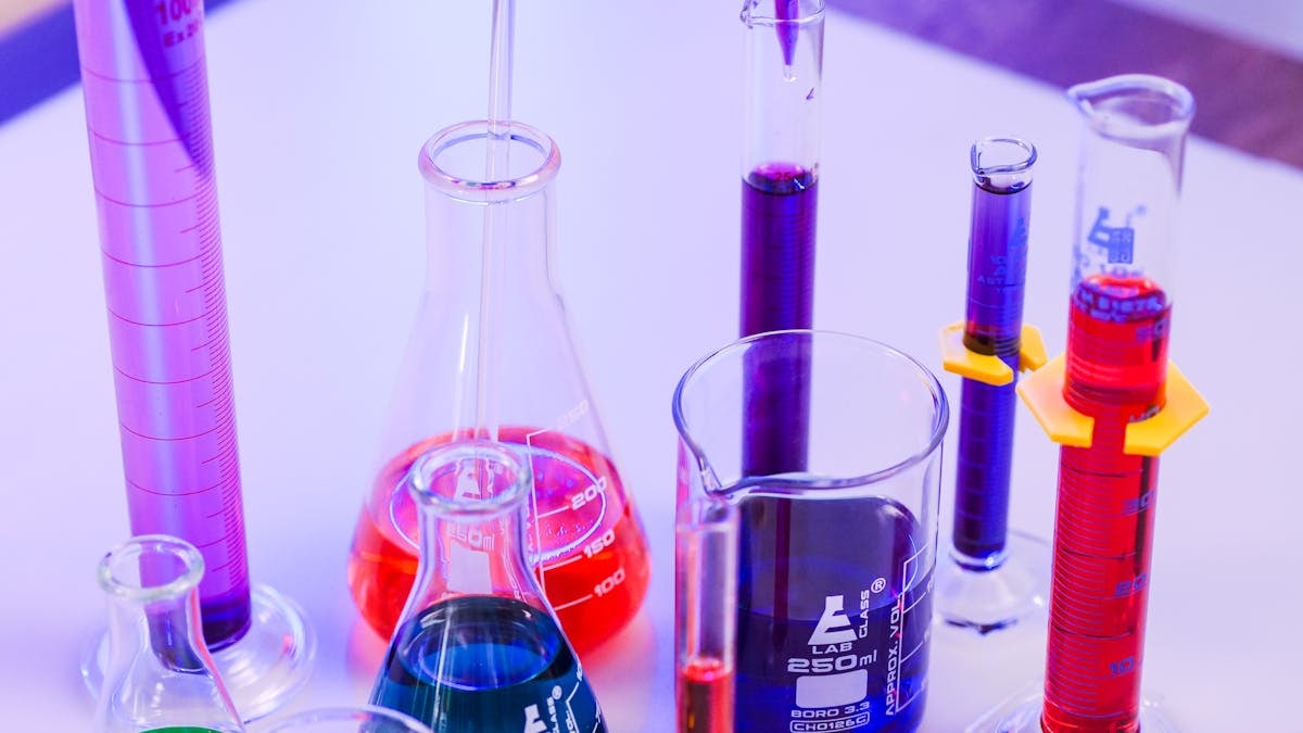 Vivid colored liquids in laboratory glassware for scientific research.